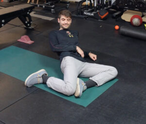Jon S leaning back onto one elbow stretching his front hip flexor and quad 